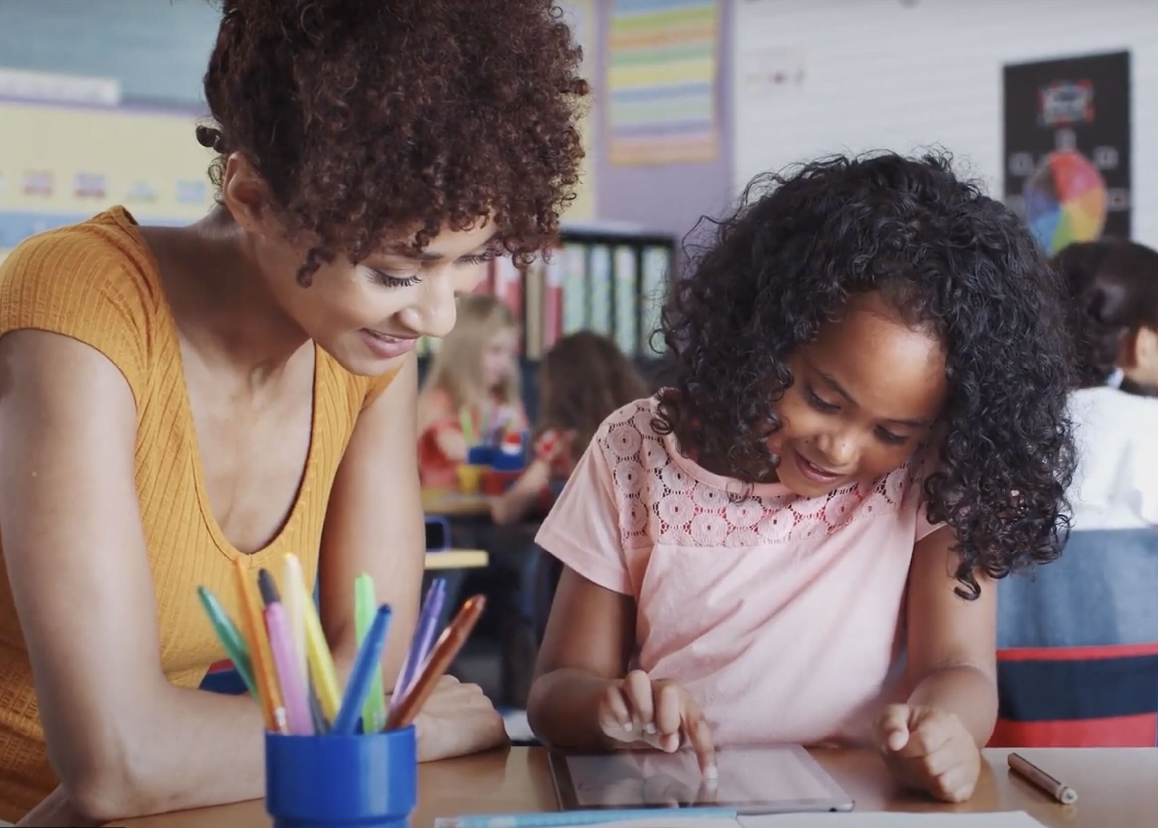 A teacher works one-on-one with an elementary school student