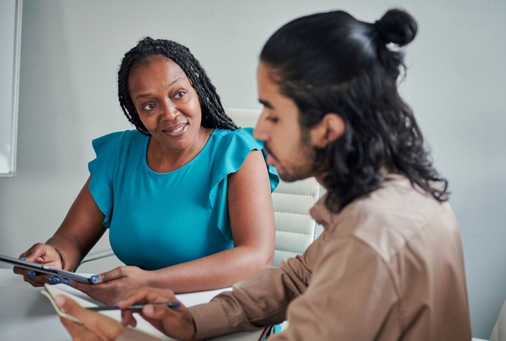 An advisor counsels a young professional