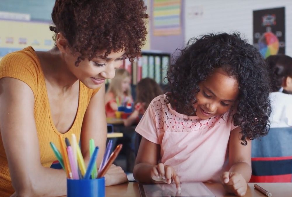 Teacher works with an elementary school students one on one.