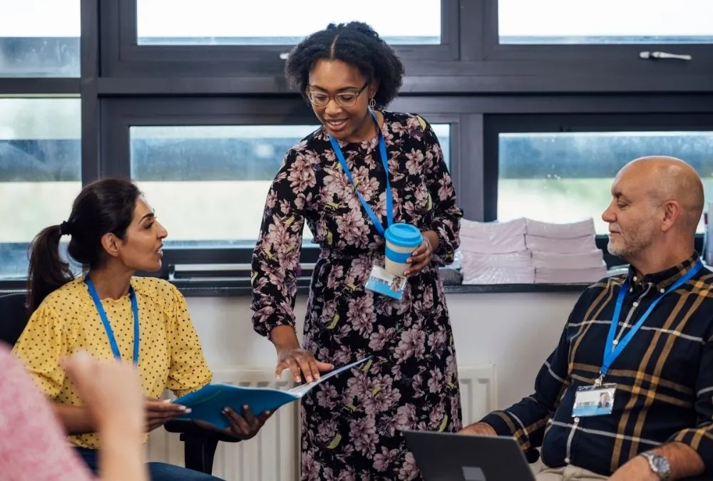 Three professionals at a conference network together