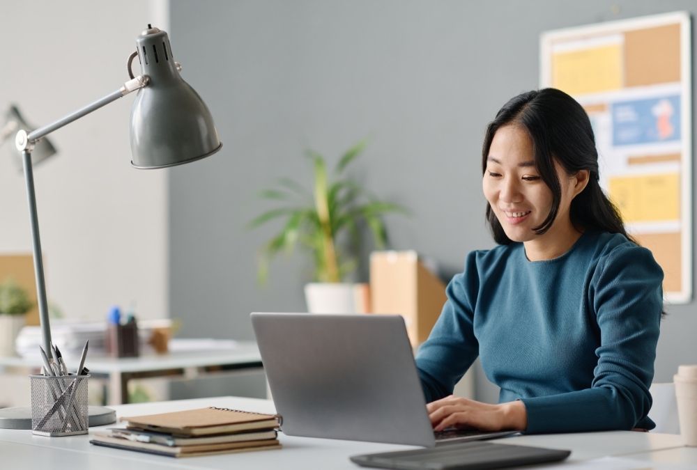 A professional woman works at her computer
