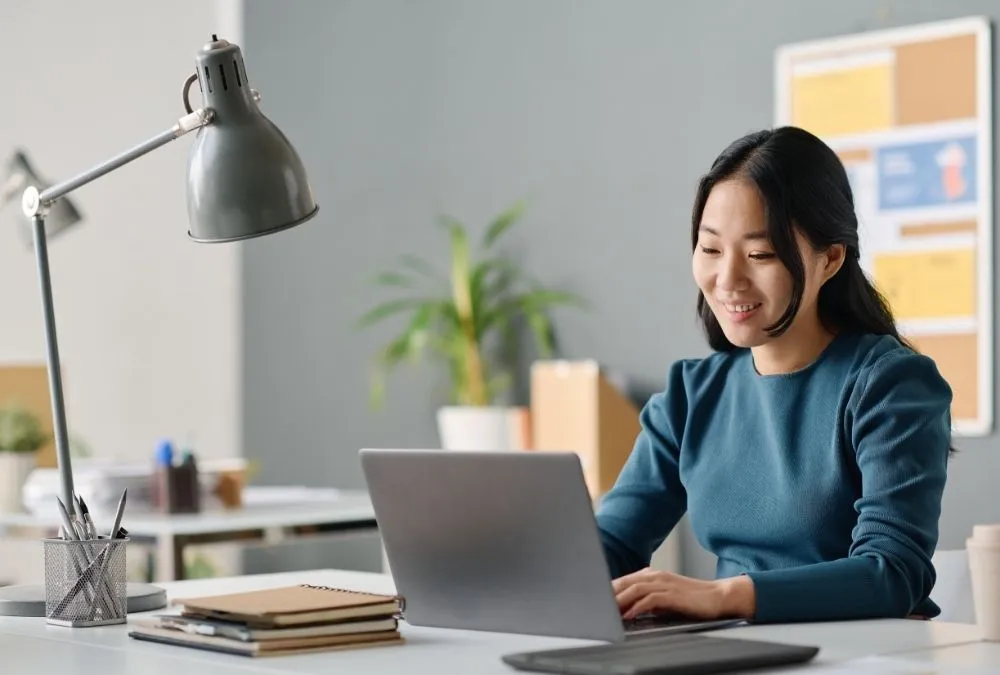 A professional woman works at her computer