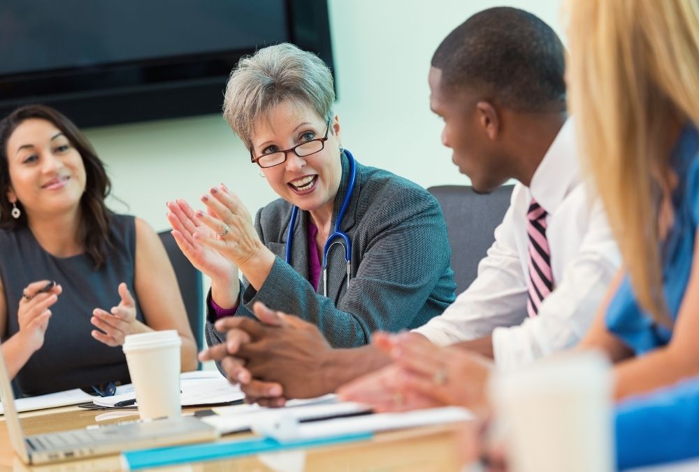 Healthcare professionals meet around a conference table