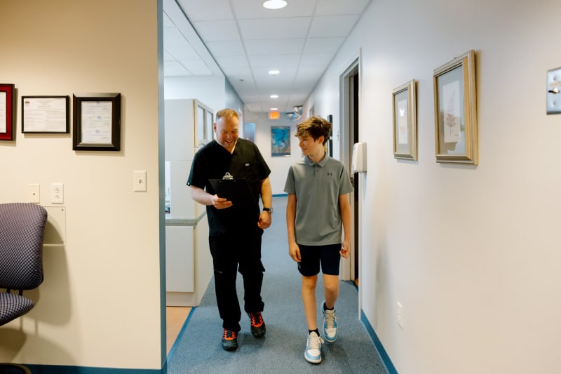 Pediatric dentist with school age boy during oral health checkup