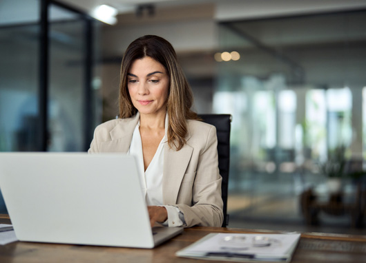 stock photo woman at desk with laptop