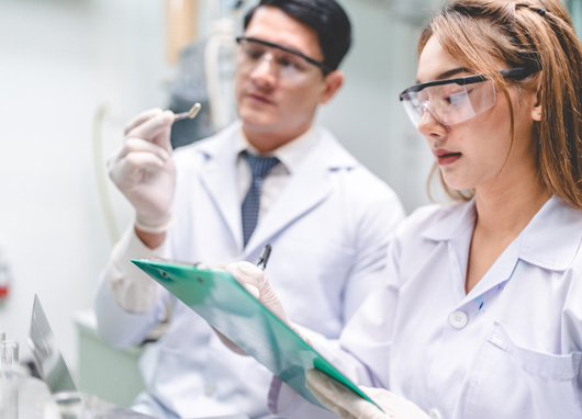 stock photo two scientists in lab coats