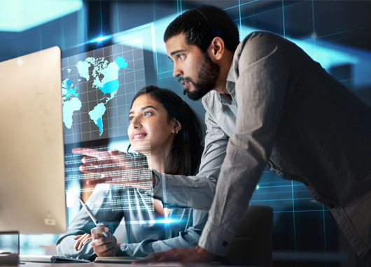 stock photo man and woman conversing at computer