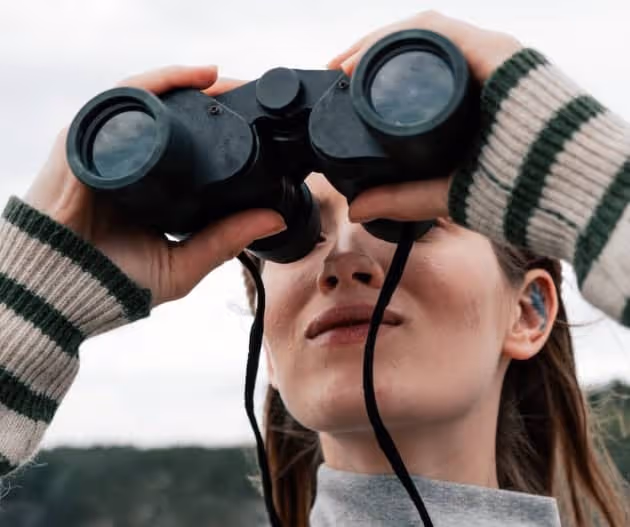 stock photo woman looking through binoculars