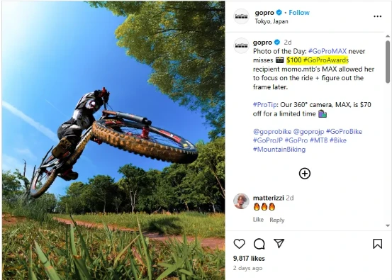 Instagram post by GoPro showing a low-angle action photo of a mountain biker mid-jump on a forest trail, with caption promoting the GoPro MAX camera and GoPro Awards.