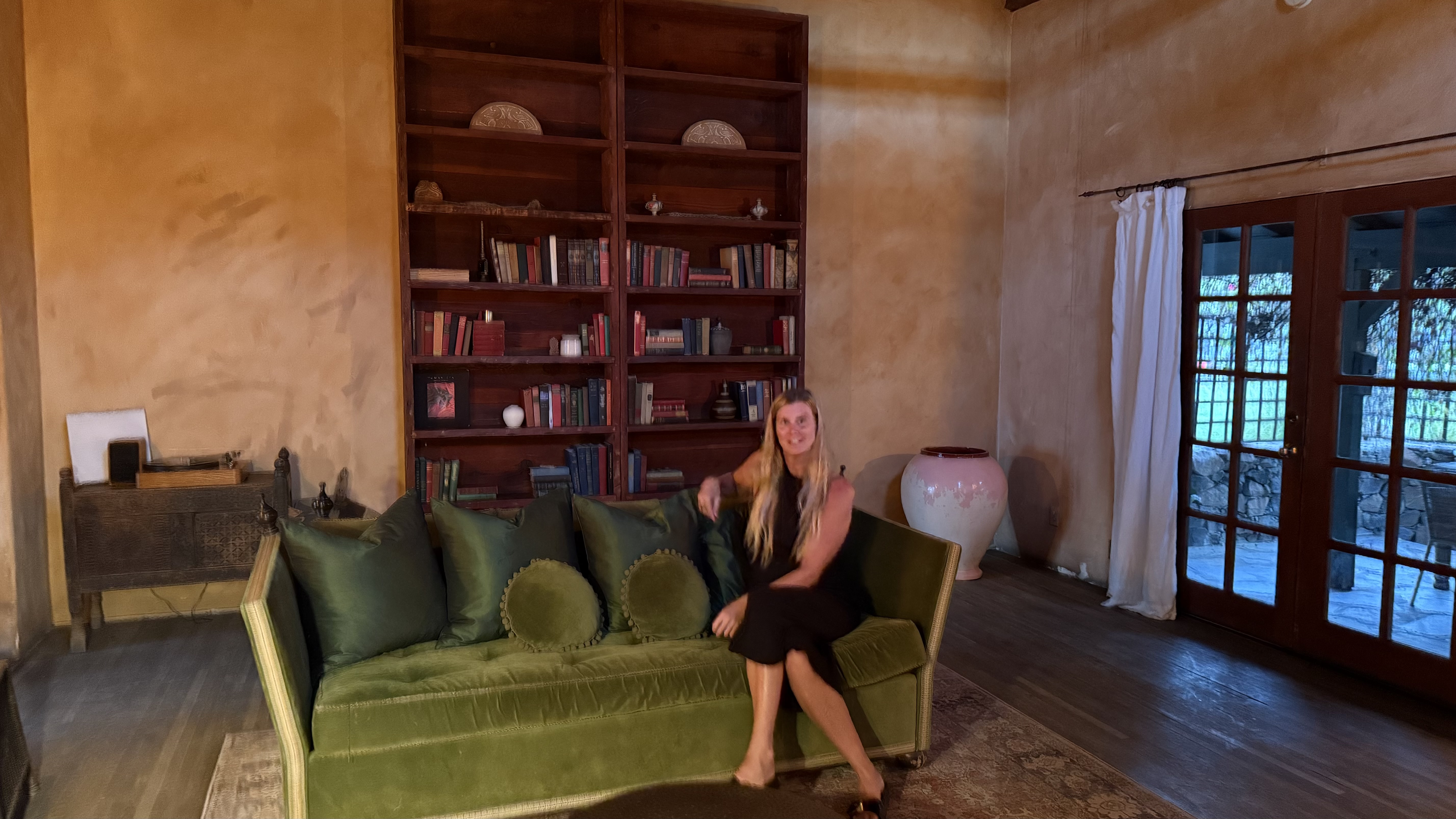 Photo of book[ed] founder Kim, posing with her husband and daughter on the beach.