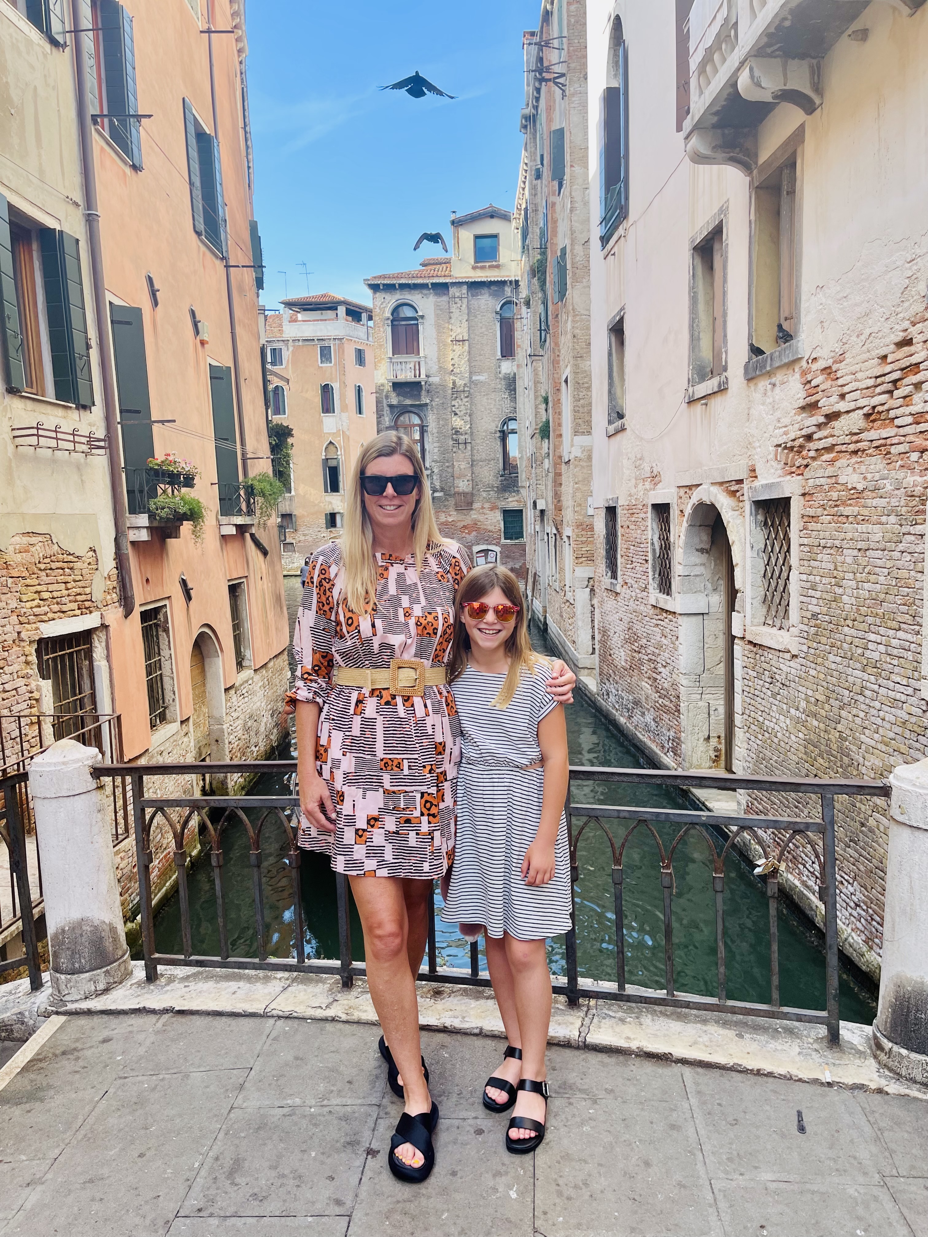 Photo of book[ed] founder Kim, posing with her husband and daughter in a snowy mountain setting.