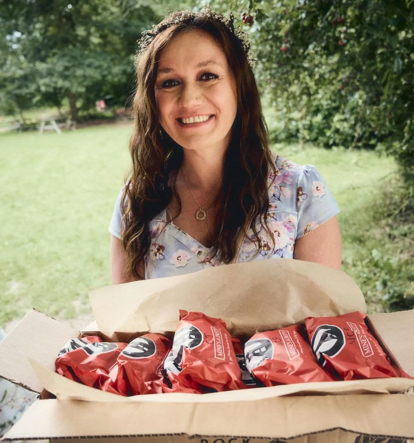 a beautiful lady holding a box with pastries