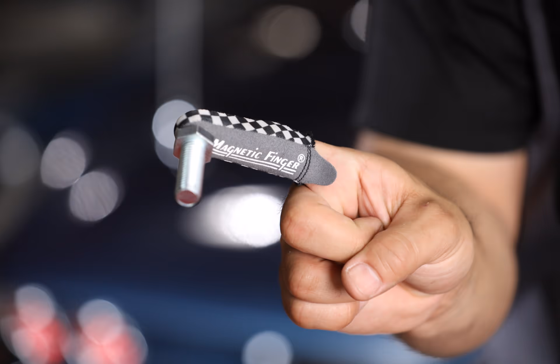 Magnetic finger device worn on hand with checkered pattern