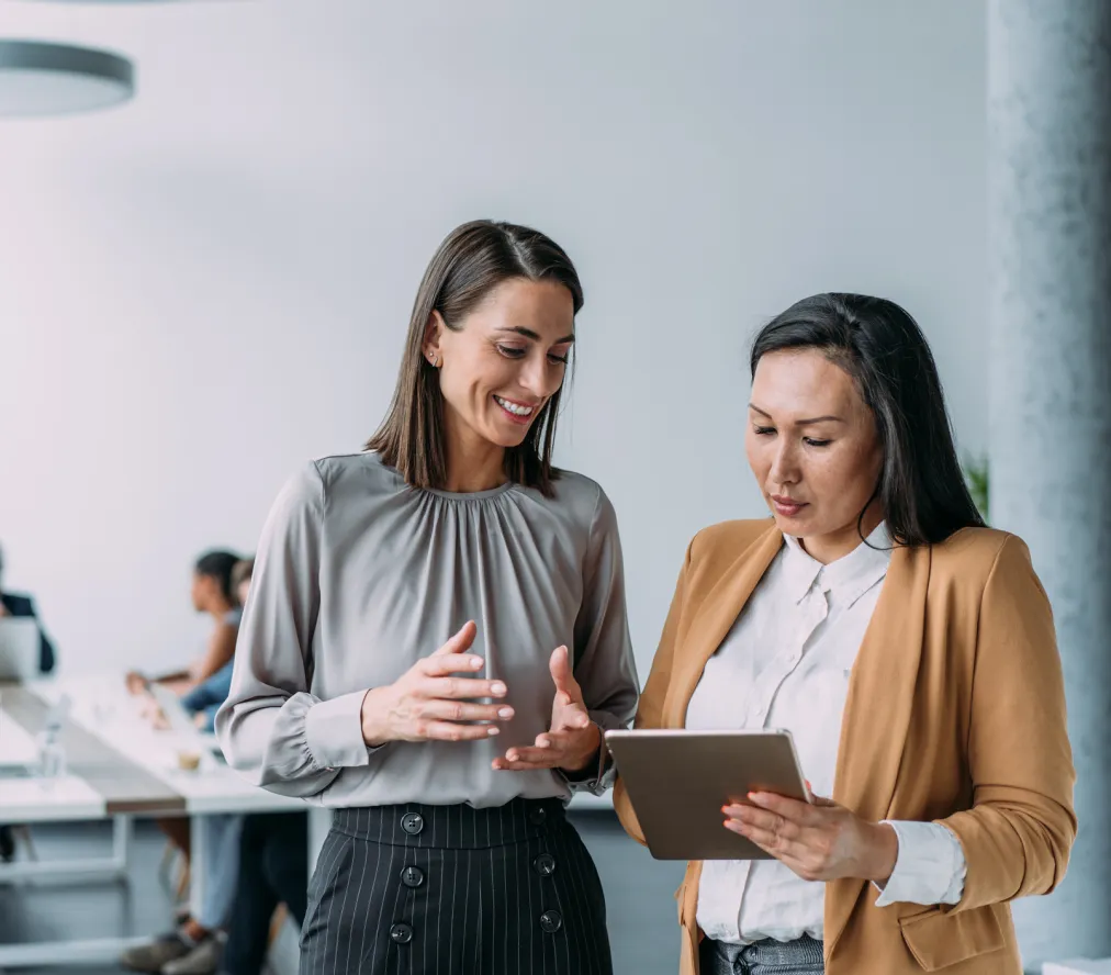 Two business people looking at a tablet in an office