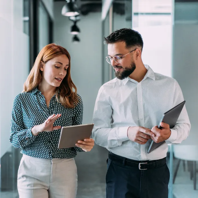 Two business people looking at a tablet in an office