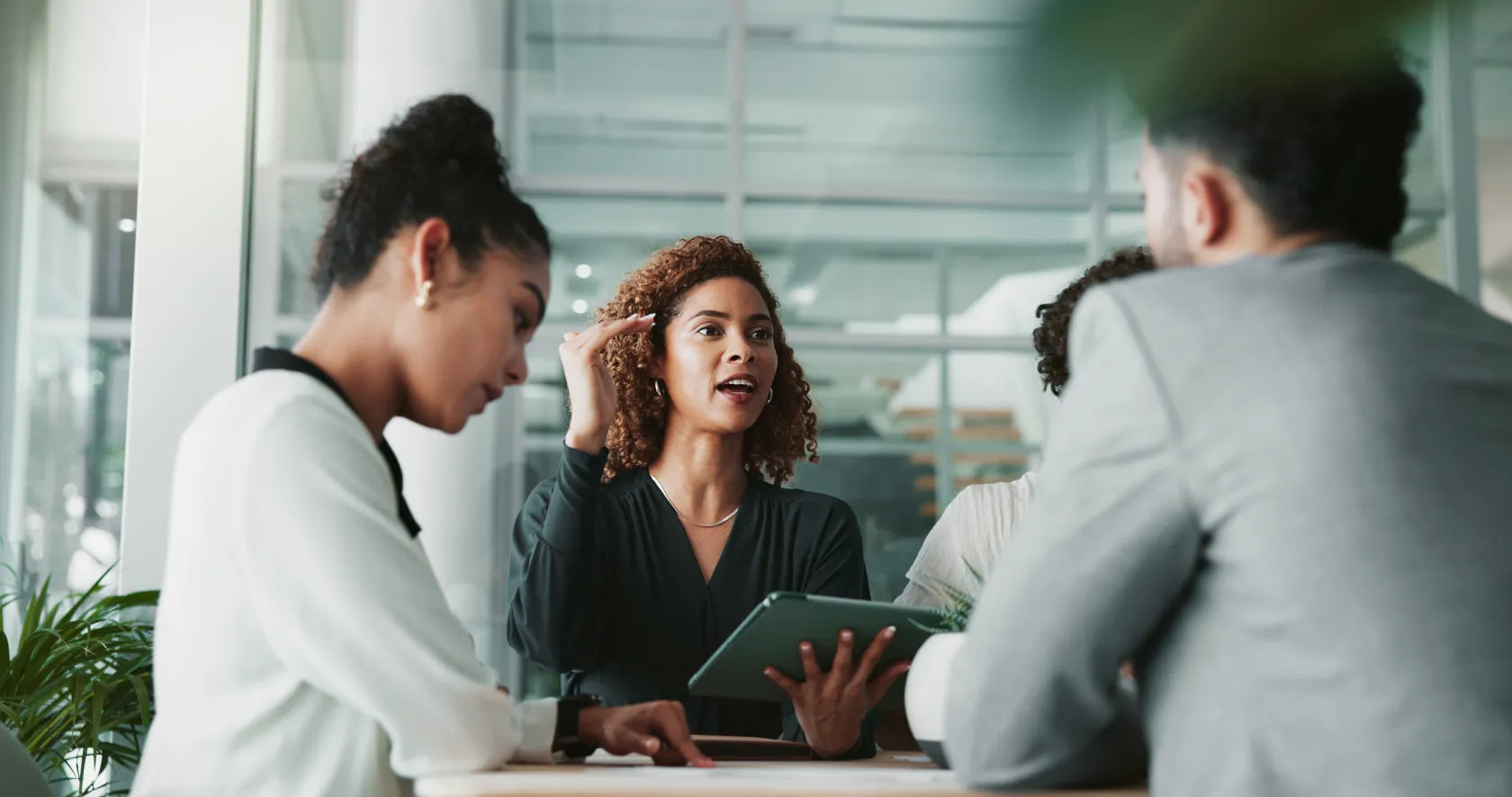 A businesswoman talking to colleagues gathered around