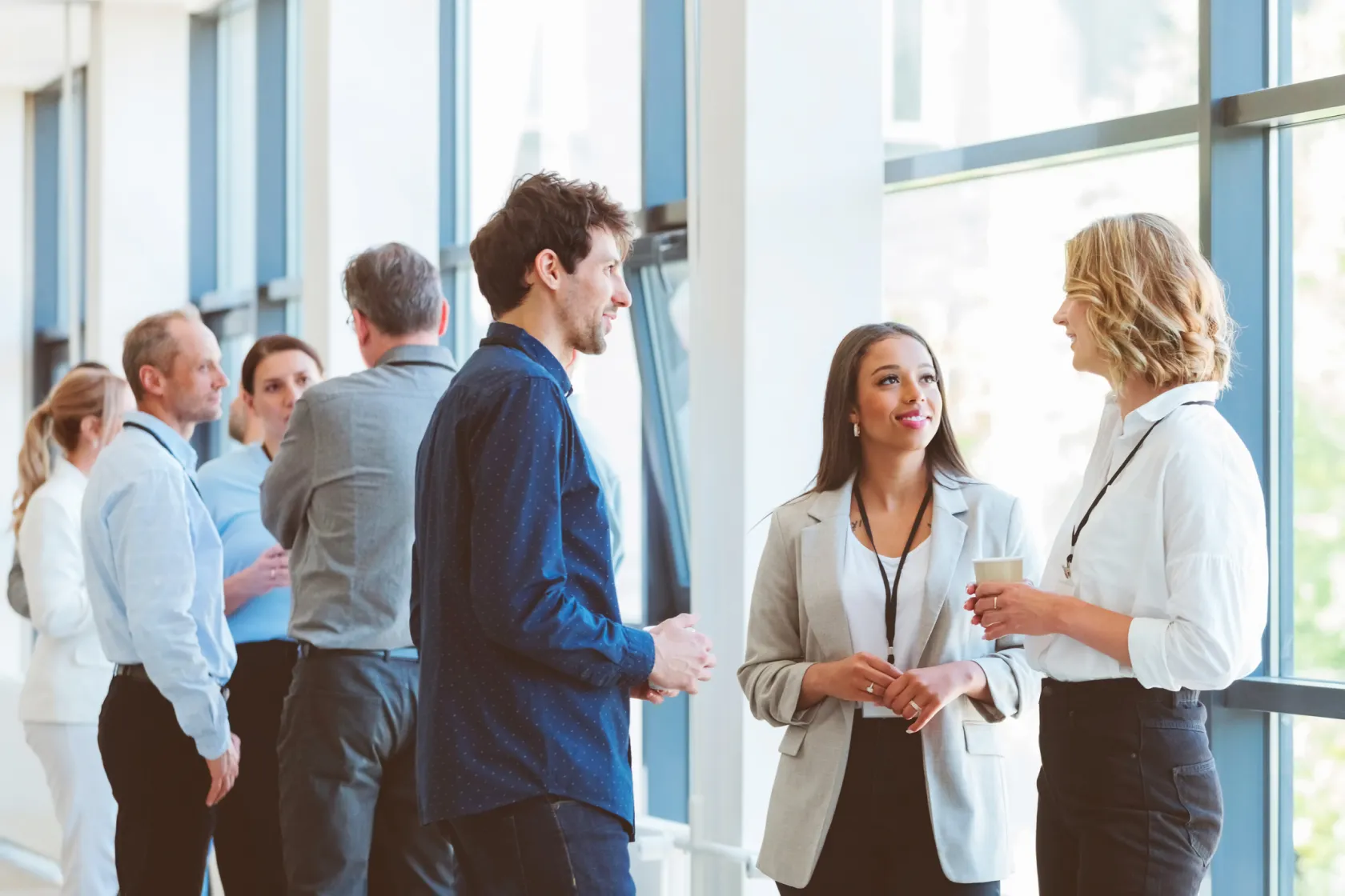 Groups of people talking while at a business conference event