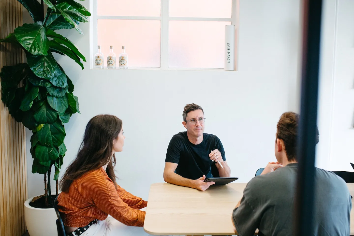 Elliot Maher sitting with the n4 table in a well lit meeting room.