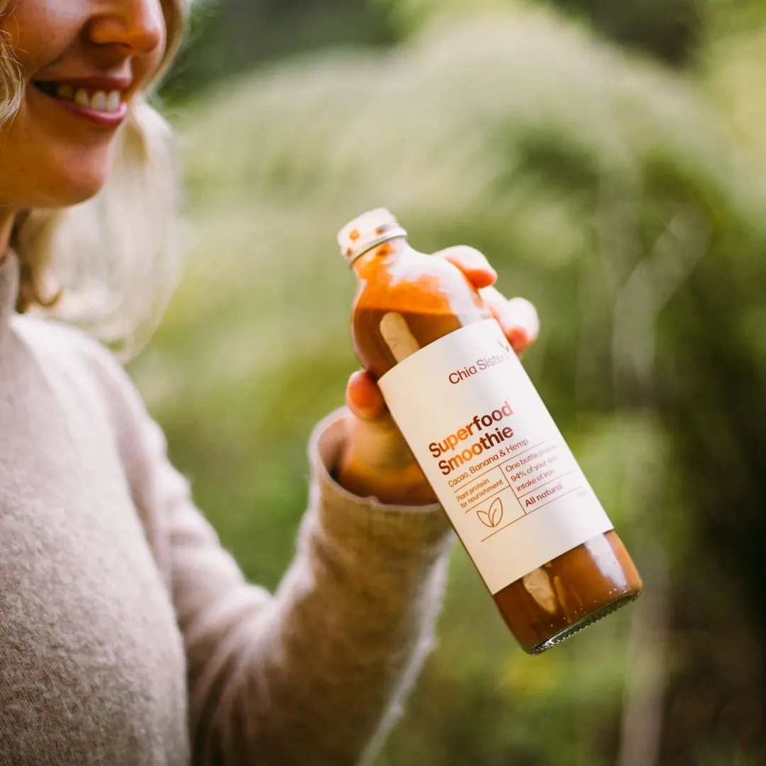 Hand picking Chia Sisters bottle out of the box