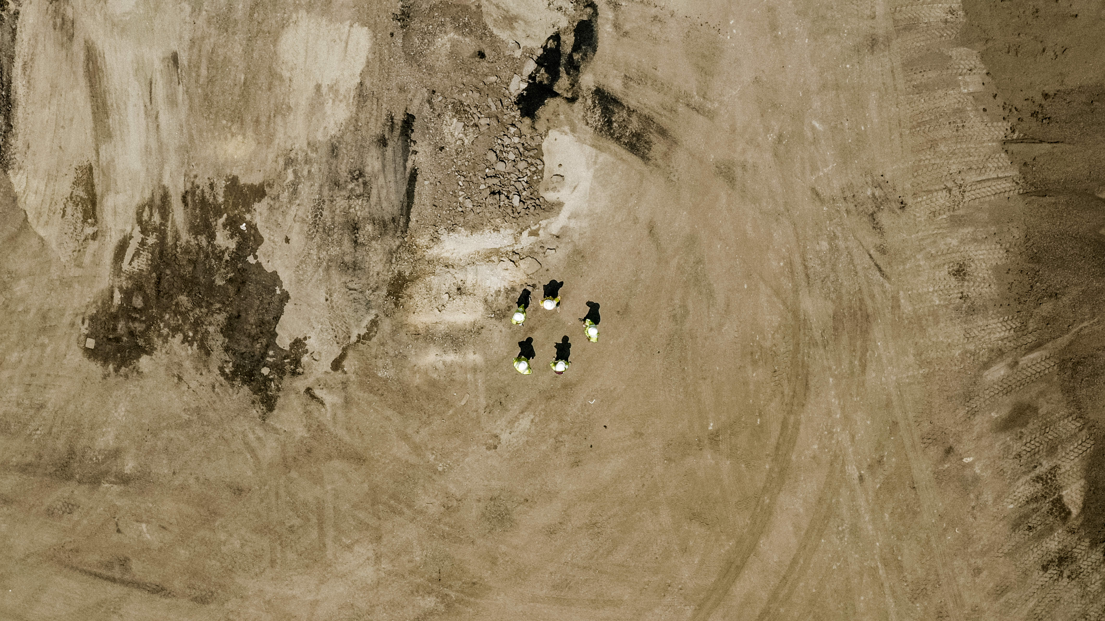 Shirley Gap 64: Workers beside aggregate stockpiles, viewed from above.