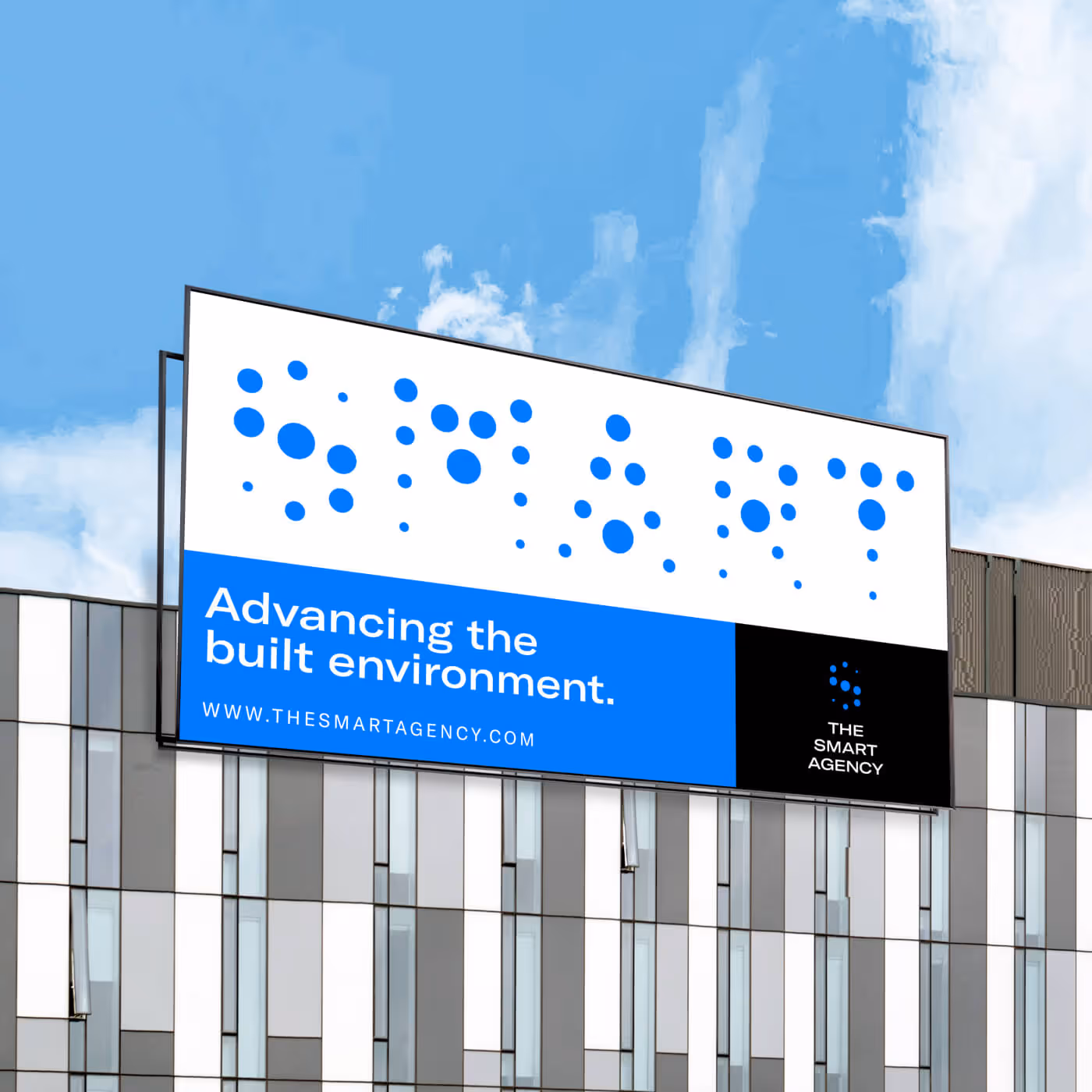 Large outdoor billboard on modern building displaying The Smart Agency branding and tagline