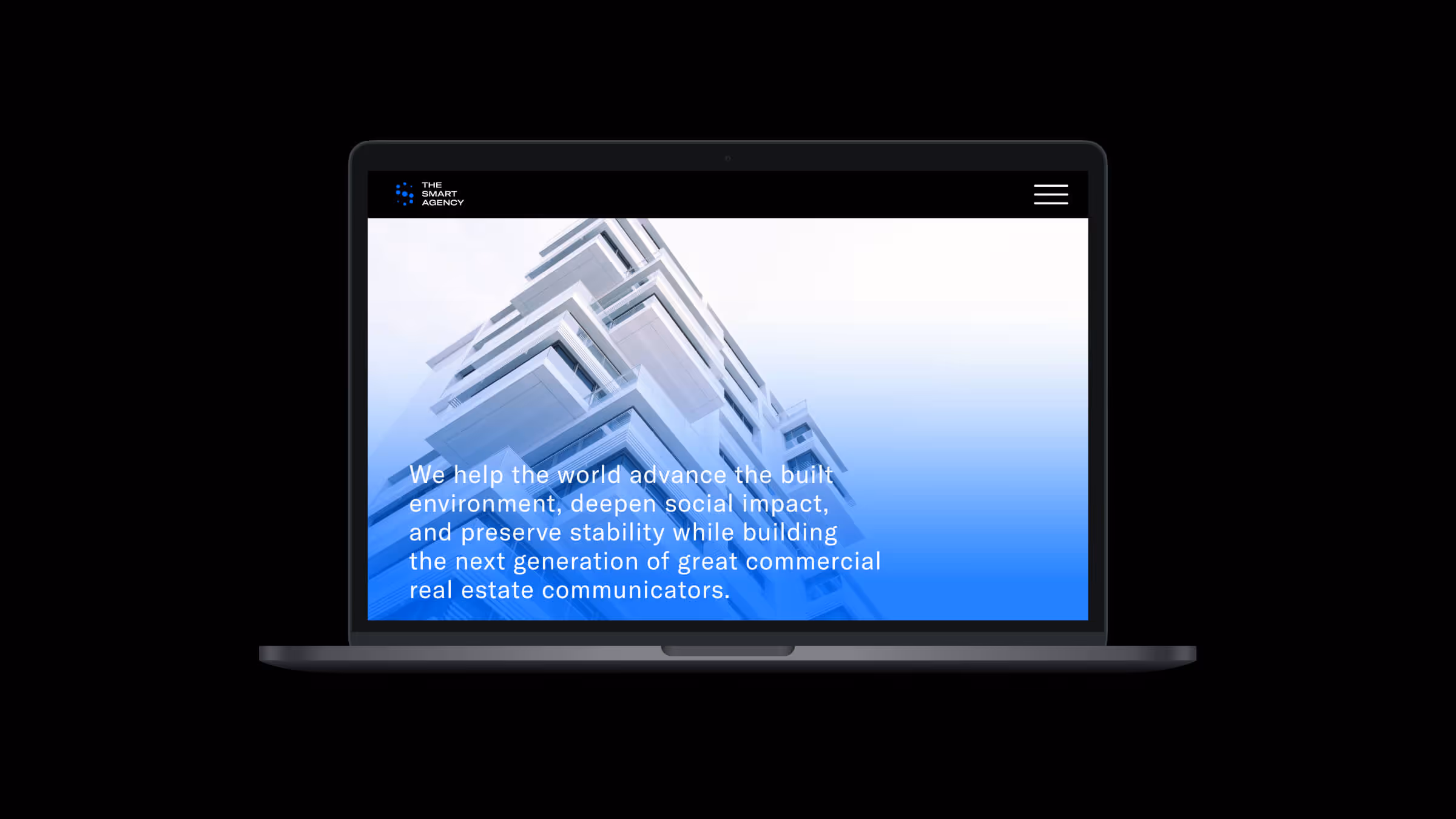 The Smart Agency website homepage on laptop displaying mission statement with building imagery