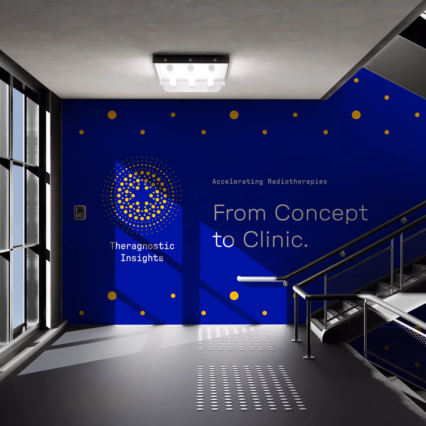 Large scale royal blue environmental wall graphic featuring Theragnostic Insights logo and From Concept to Clinic tagline with gold dot accents