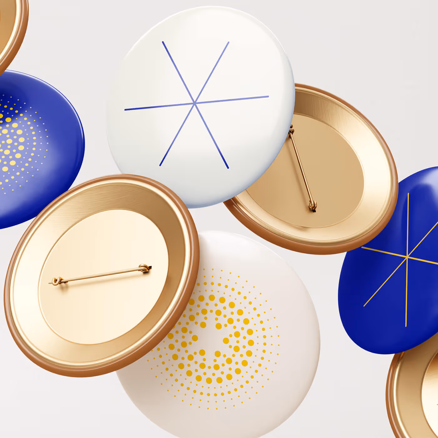 Collection of branded buttons featuring gold dot pattern, blue geometric star, and white designs with gold accents