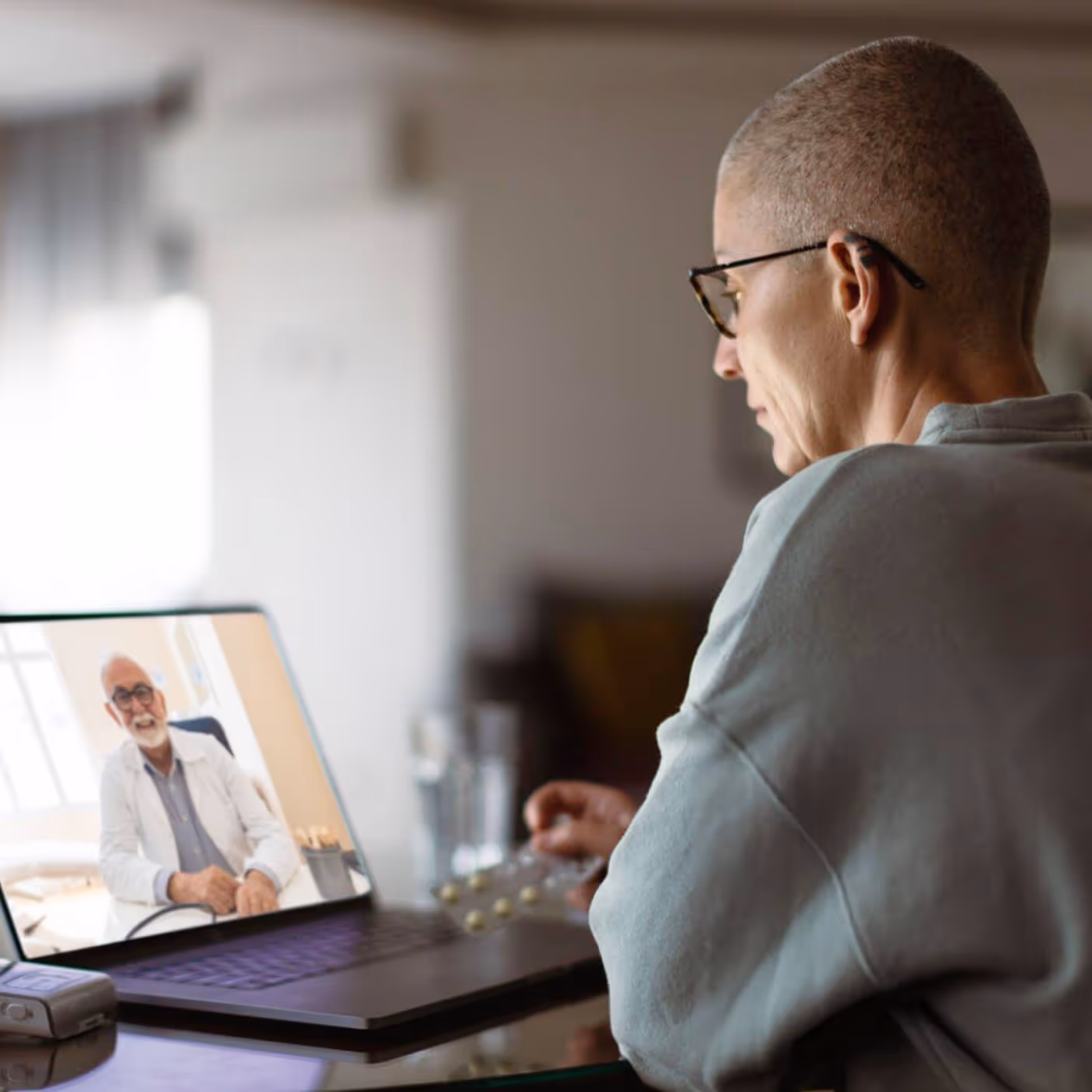 Patient in video consultation with doctor on laptop screen
