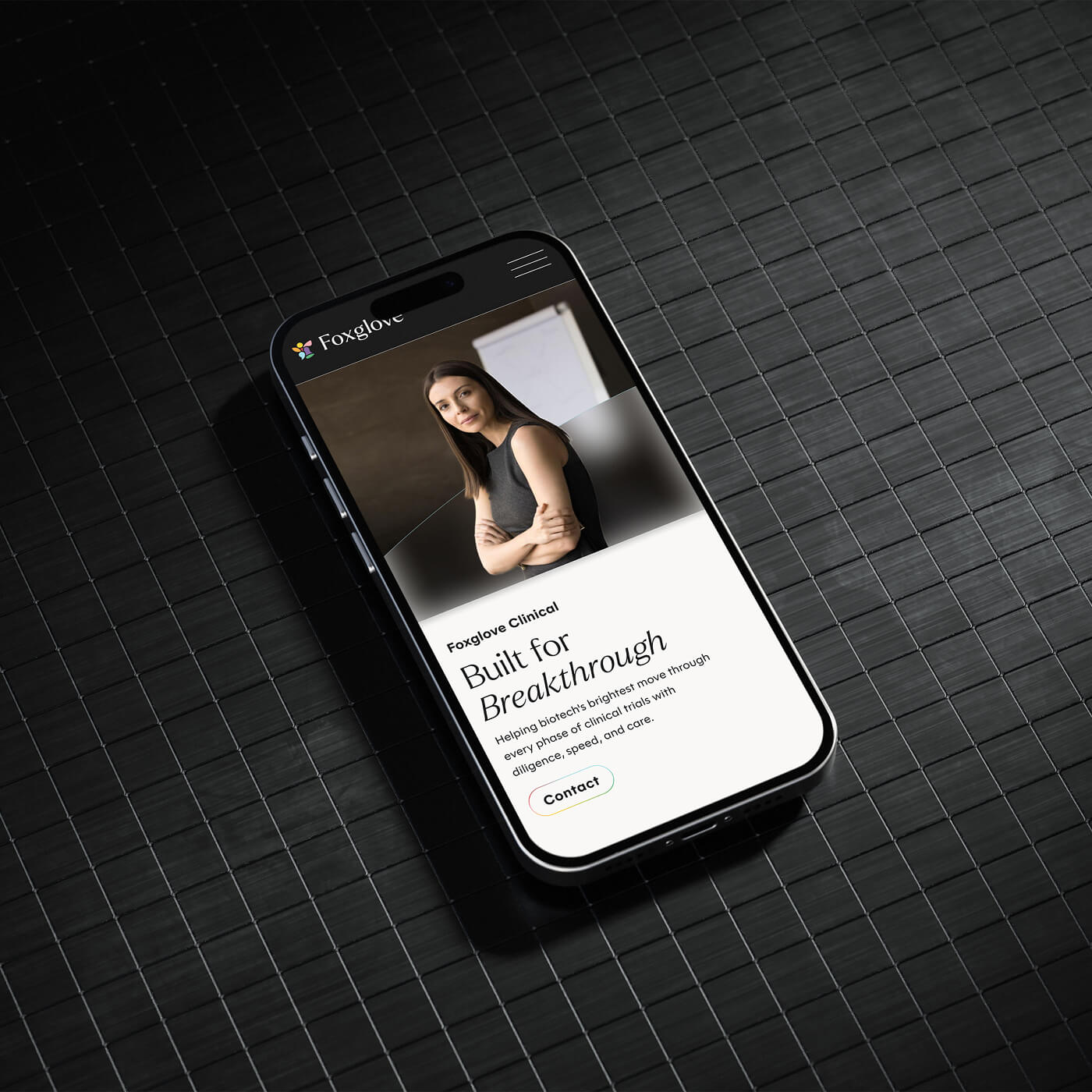 Smartphone displaying Foxglove Clinical website with a photo of a woman with crossed arms and text about biotech clinical trials.