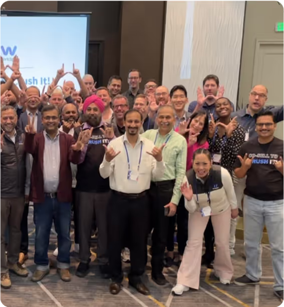 A group of people standing in front of a screen.