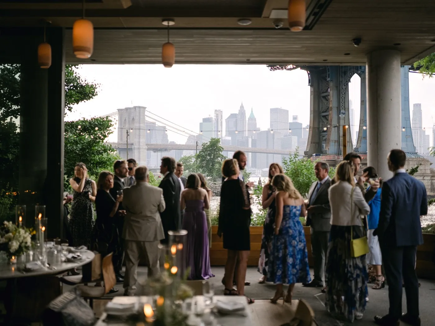 Guests gathered on Celestine's terrace with the Brooklyn Bridge and Manhattan skyline in the background