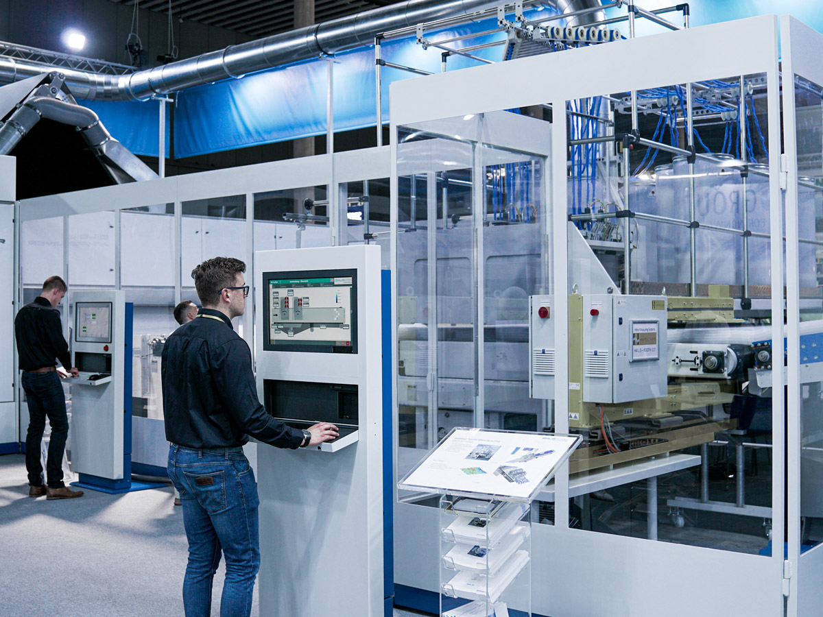 Person using computer system in commercial factory