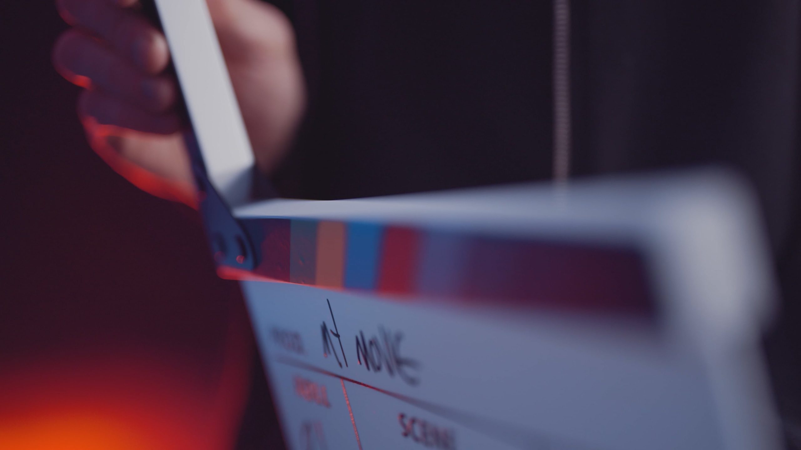 Hand holding a film clapperboard on an Identity Start video production set