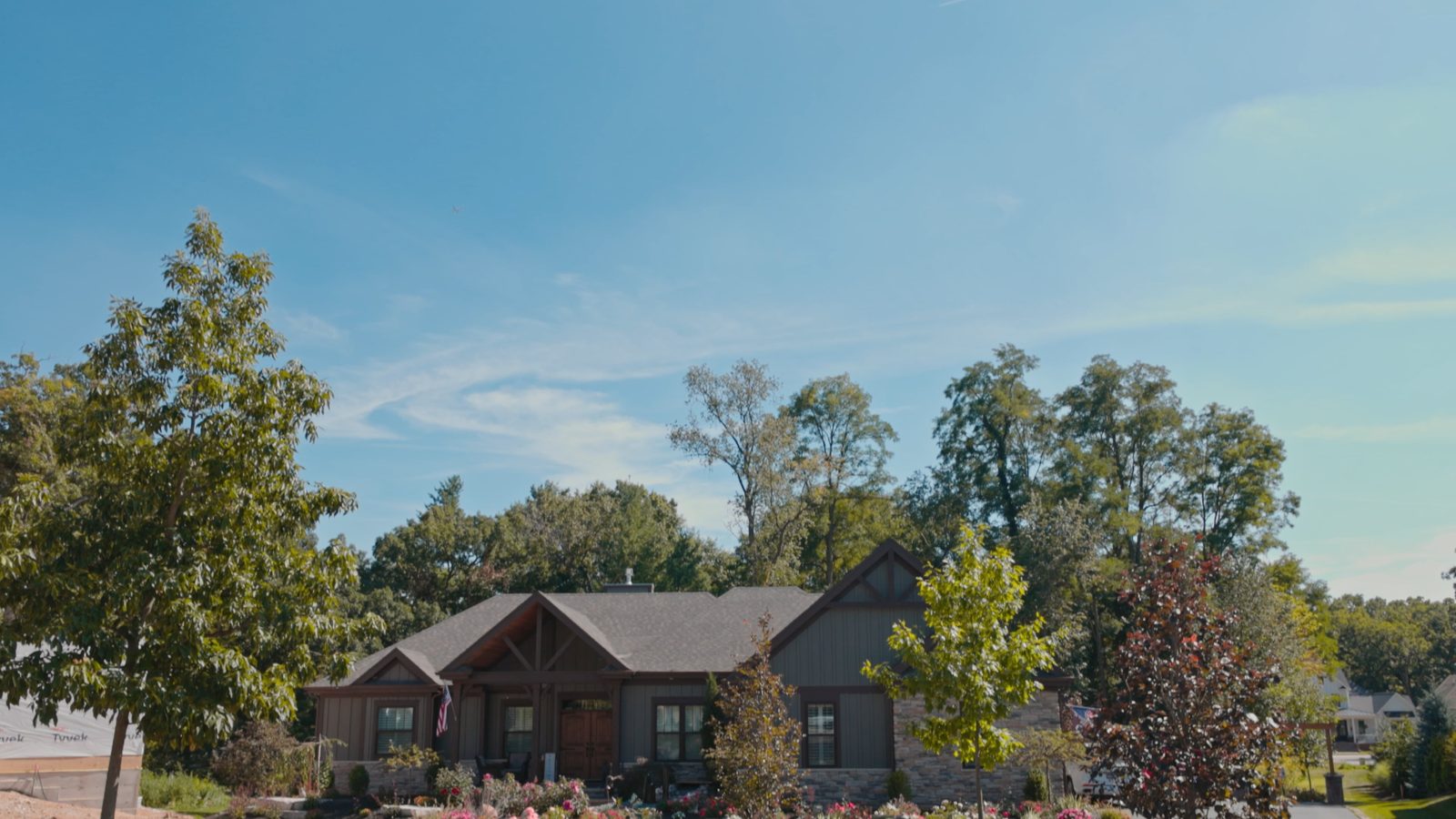 Craftsman-style home with mature landscaping and stone beds, a client project by Identity Start