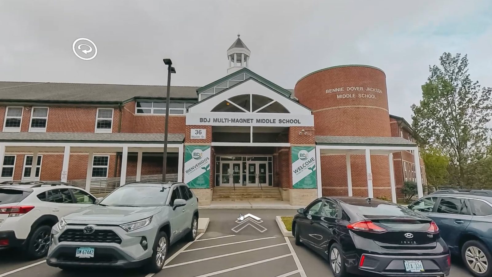 Virtual tour view outside BDJ Multi-Magnet Middle School with navigation hotspots, by Identity Start