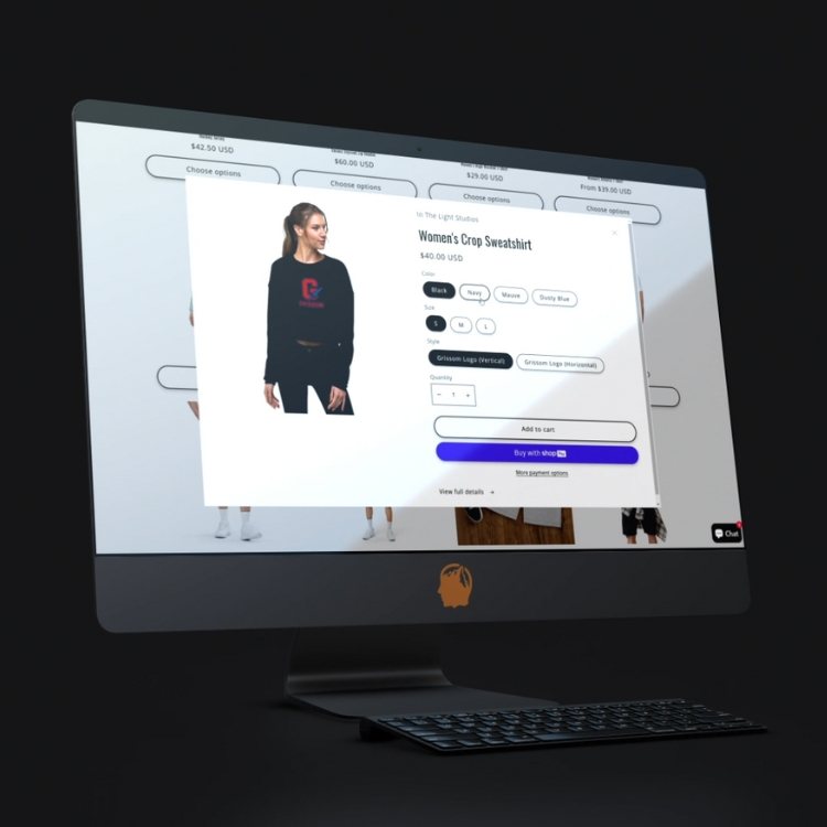 Desktop monitor showing an online store product page for a women's crop sweatshirt with size and purchase options