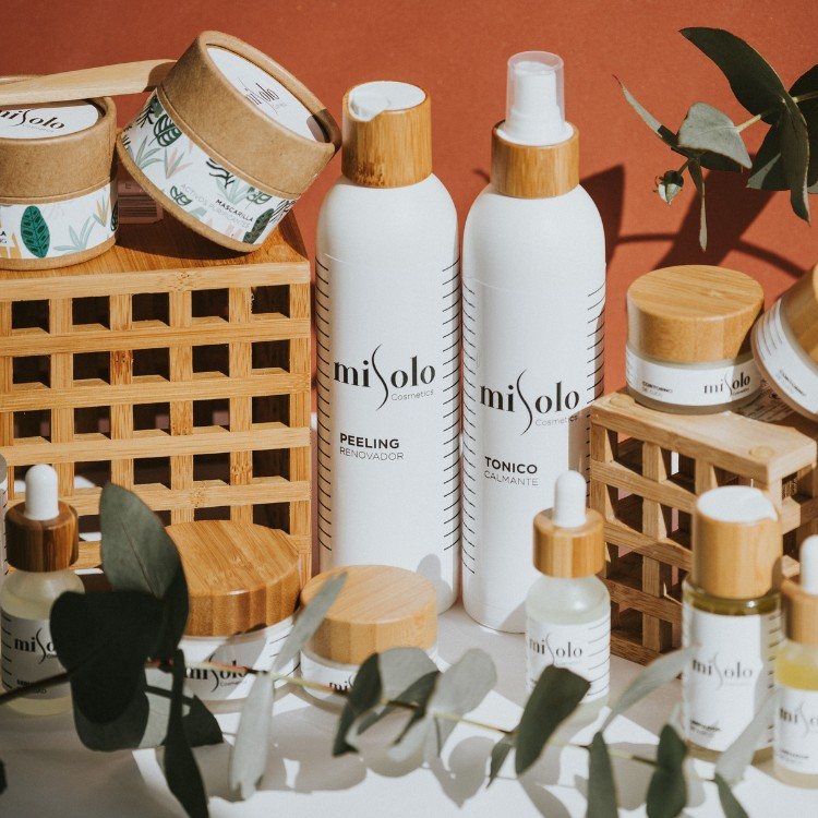 Skincare product bottles and jars with wooden lids arranged for an online store product shoot