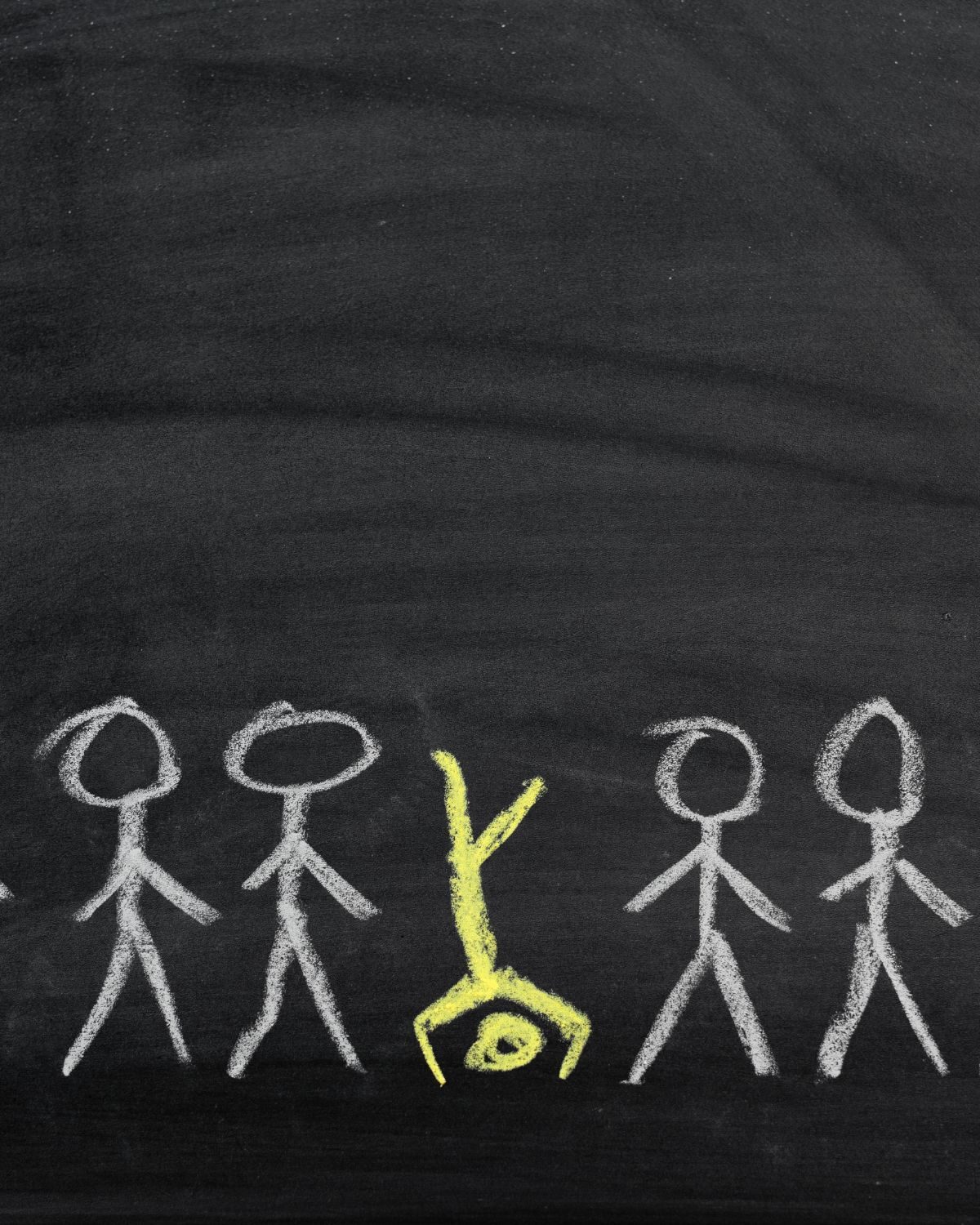 Chalk stick figures with one standing out in yellow, representing what makes a brand different