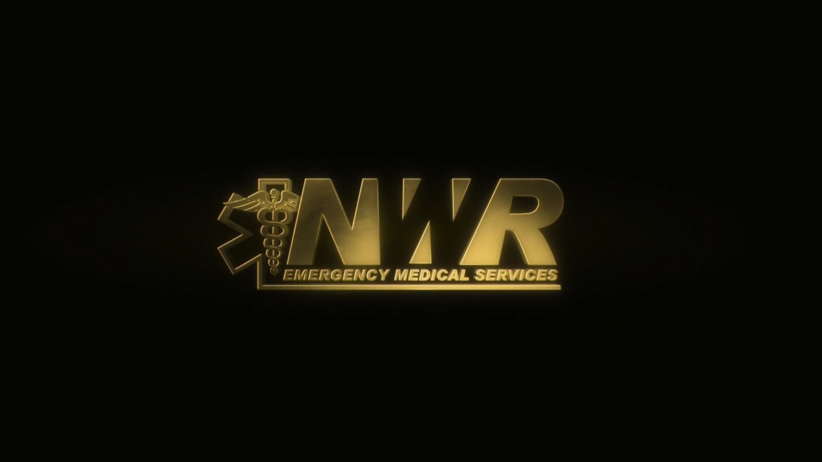 Gold glowing NWR Emergency Medical Services logo on a black background
