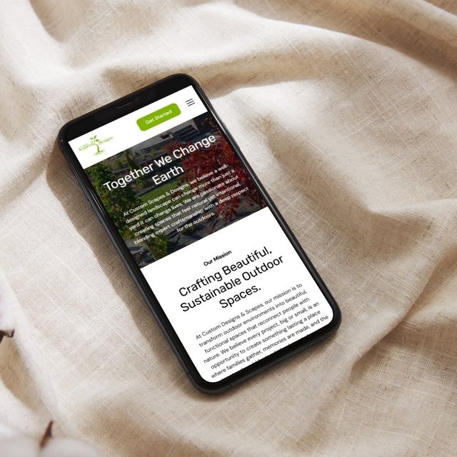 Custom Scapes & Designs website on a phone, designed by Identity Start