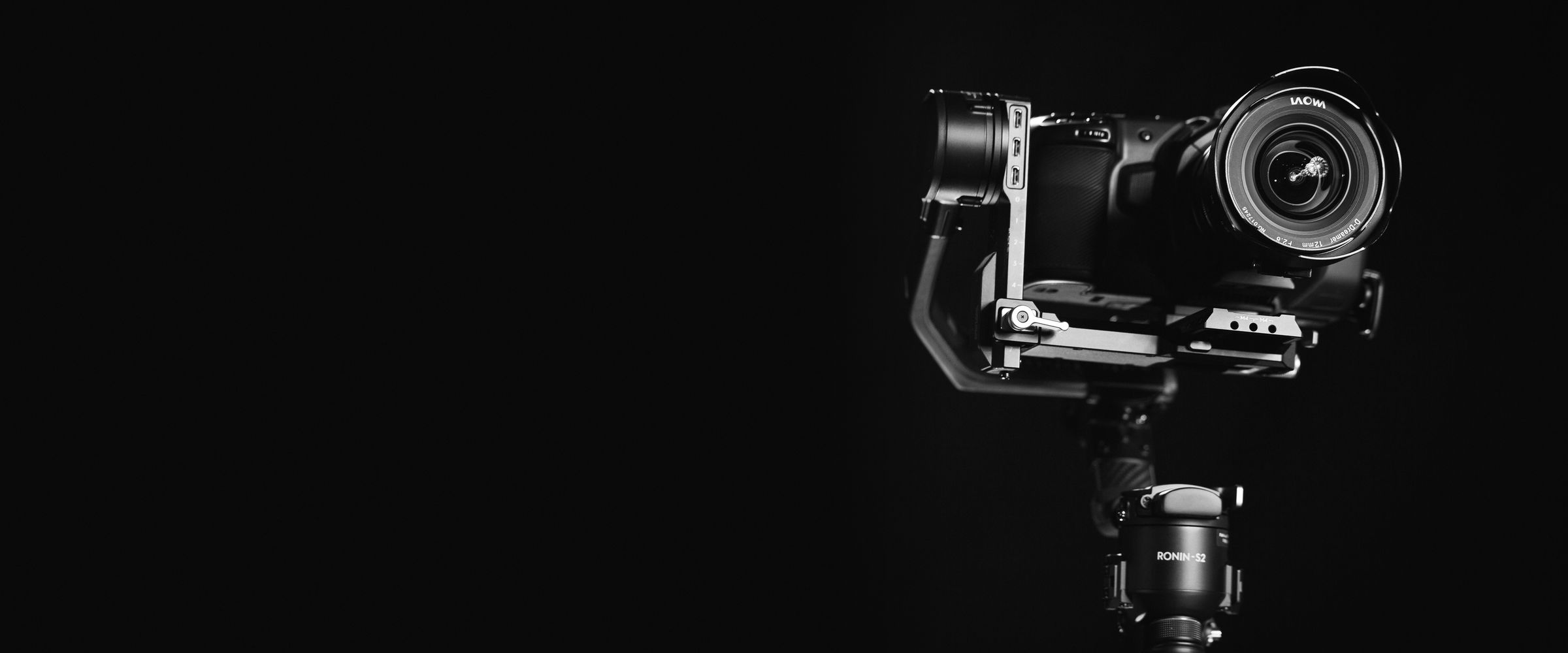 Cinema camera with a wide-angle lens on a Ronin-S2 gimbal against a black background