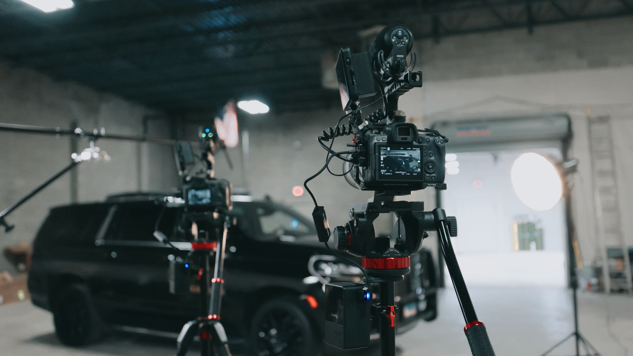 Cinema camera rigs set up around a Northwest Rescue SUV on an Identity Start video set