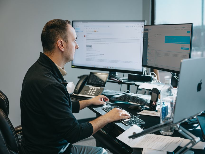 Northwest Rescue team member working at a multi-monitor dispatch desk