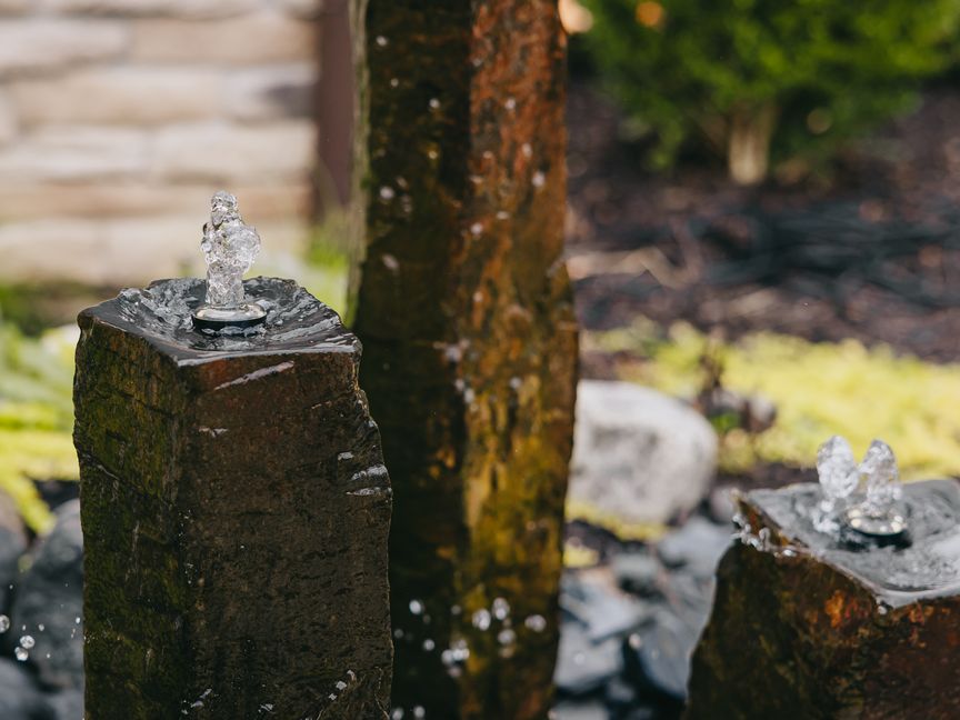 Bubbling basalt column water feature installed by Custom Scapes & Designs