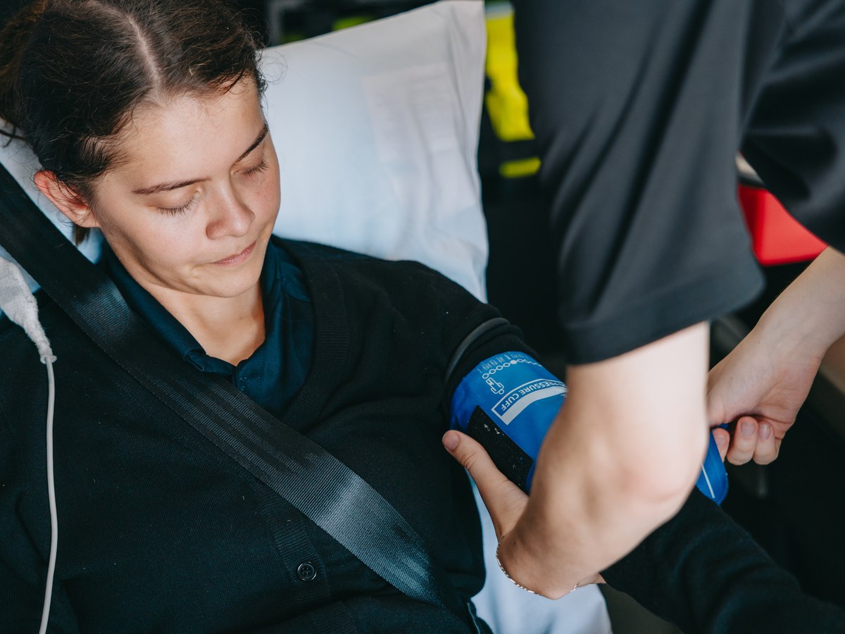 Stark County Ambulance EMT checking a patient's blood pressure inside the ambulance