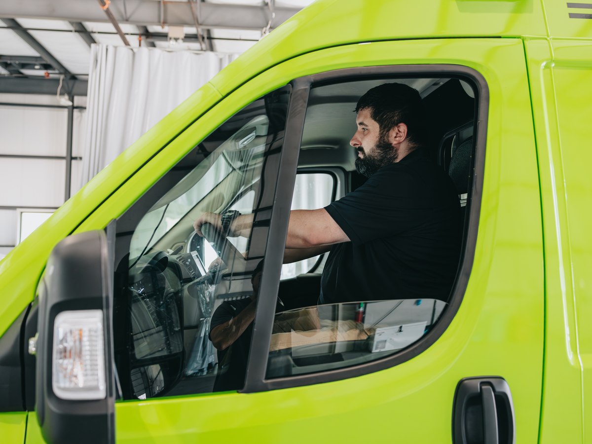 Stark County Ambulance EMT driving a lime green ambulance
