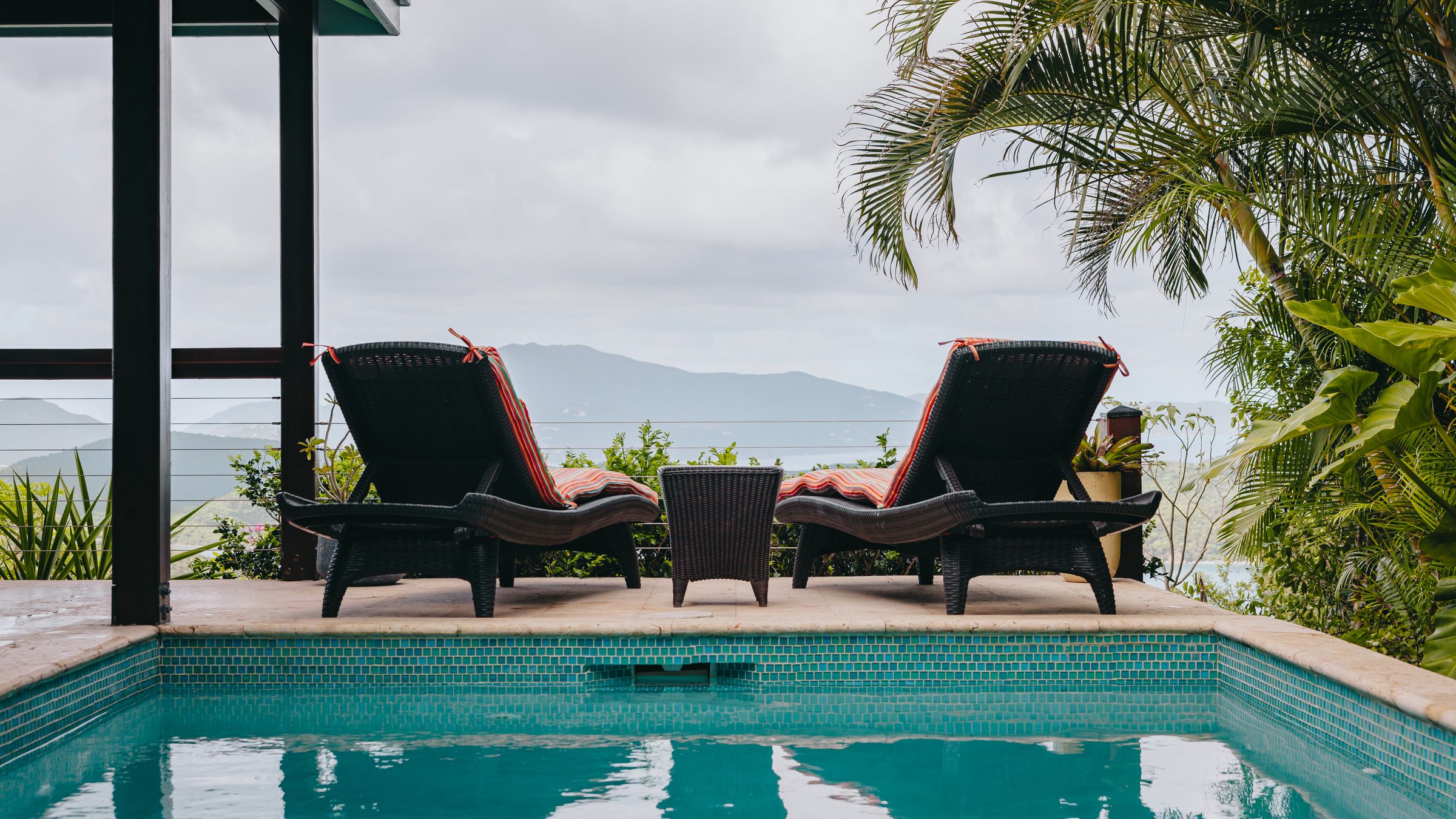 Infinity-edge pool with two lounge chairs overlooking the Virgin Islands at Moon Cottage