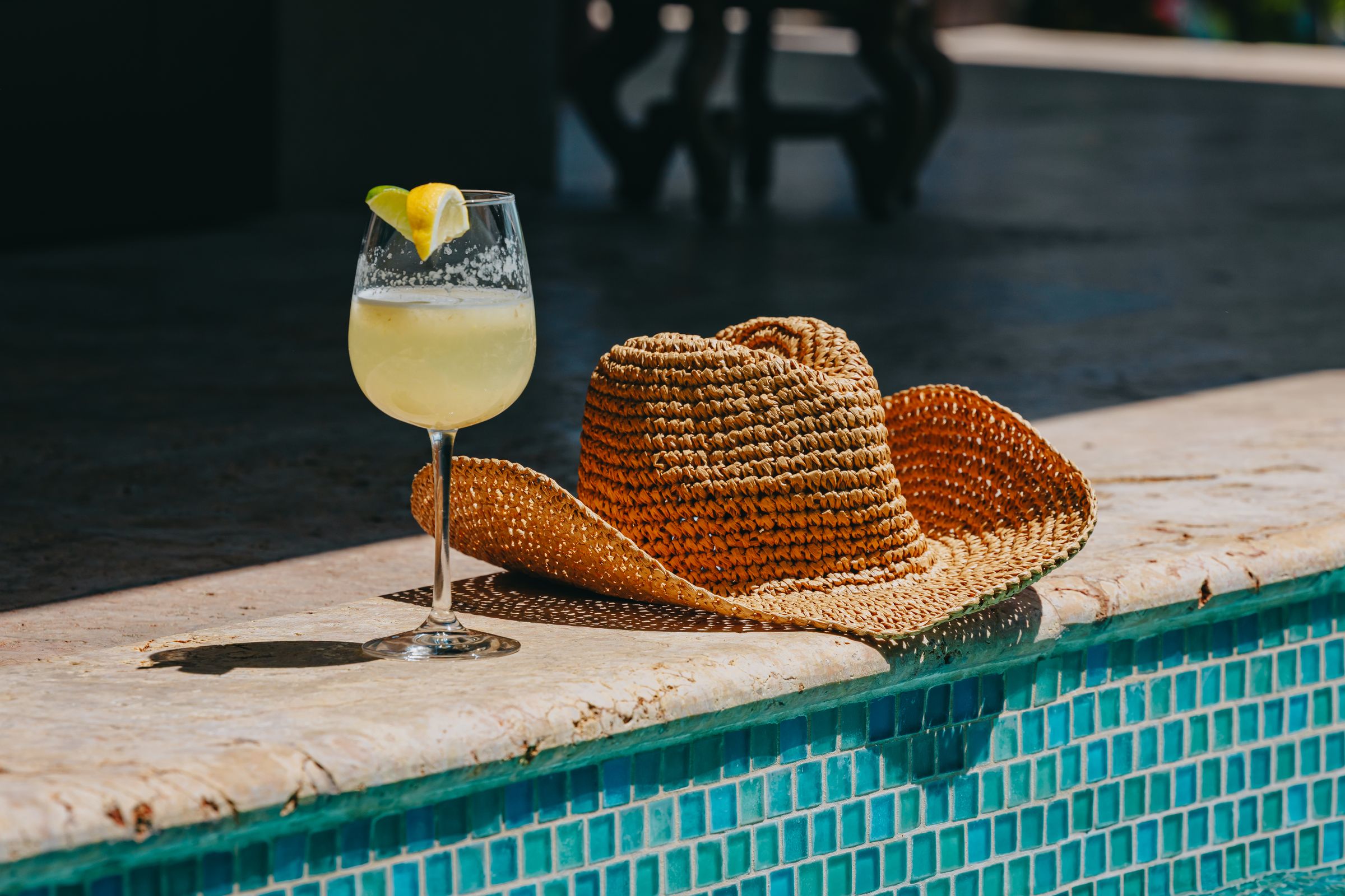 Straw hat and a cocktail on the edge of the Moon Cottage pool in the Virgin Islands