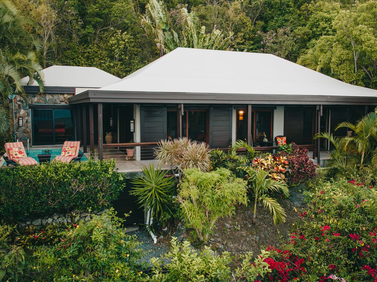 Aerial drone view of Moon Cottage surrounded by tropical gardens